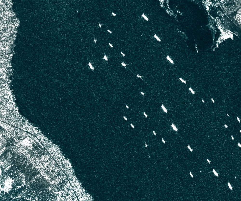 Dozens of oil tankers and commercial cargo ships line up at Great Bitter Lake to enter the Suez Canal in this March 25 satellite image provided by Ursa Space.